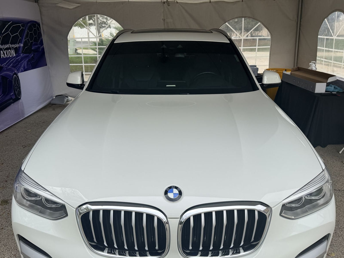 BMW X3 with IVIOS EPU windshield protection film in the IVIOS tent